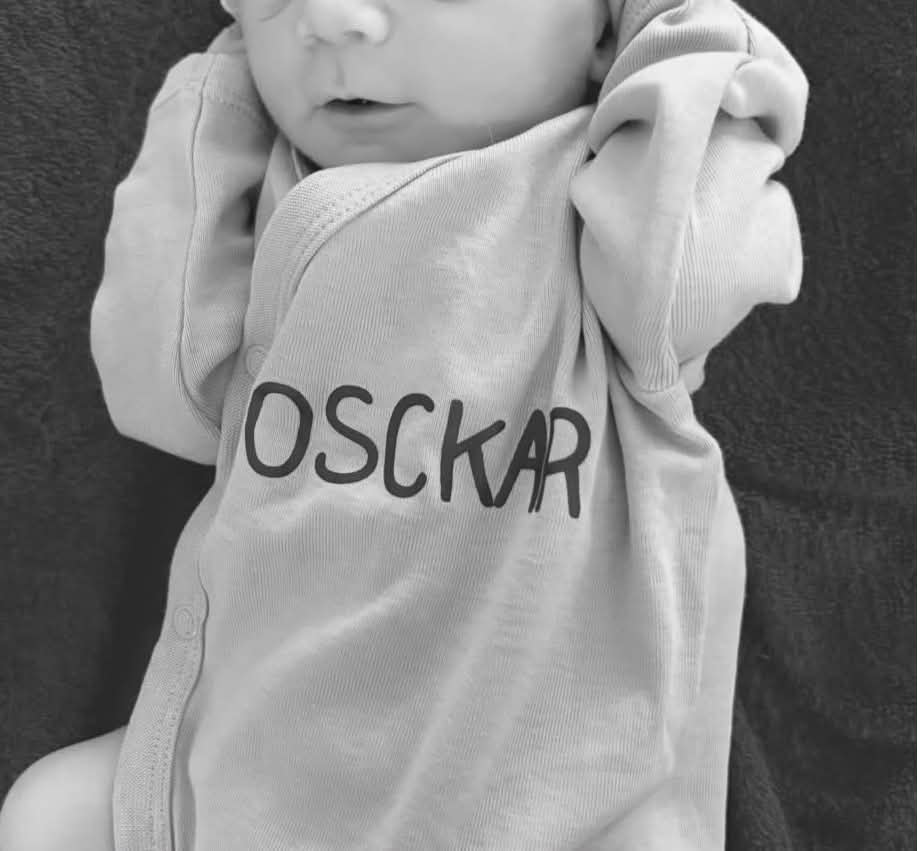 Baby met gepersonaliseerde romper 'Osckar' in zwart-wit